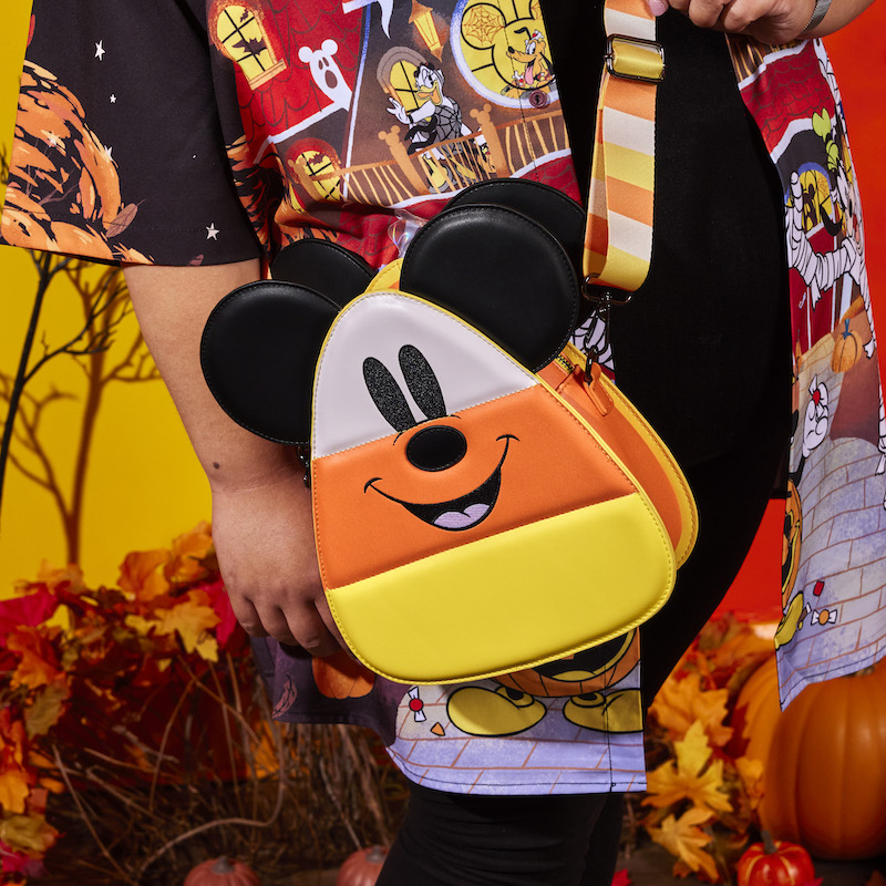 Someone wearing the Candy Corn Crossbody Bag featuring the Mickey Mouse side of the bag